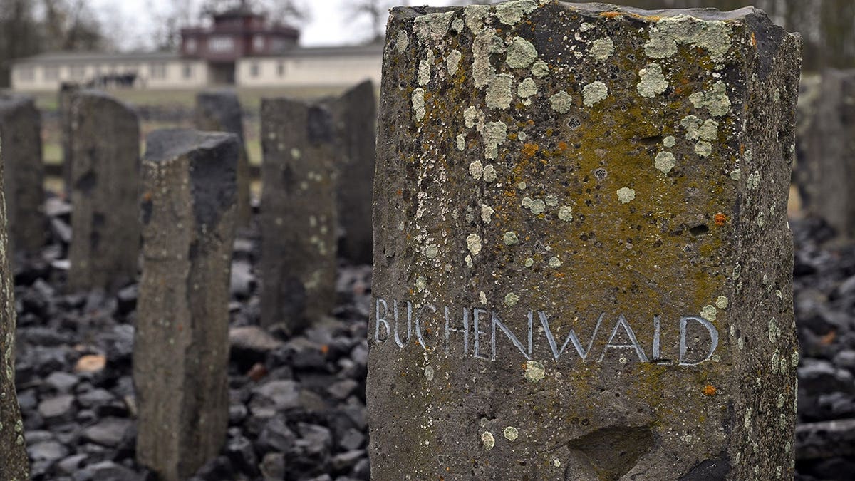 Memorial stone with inscription Buchenwald near former concentration camp gate in Weimar