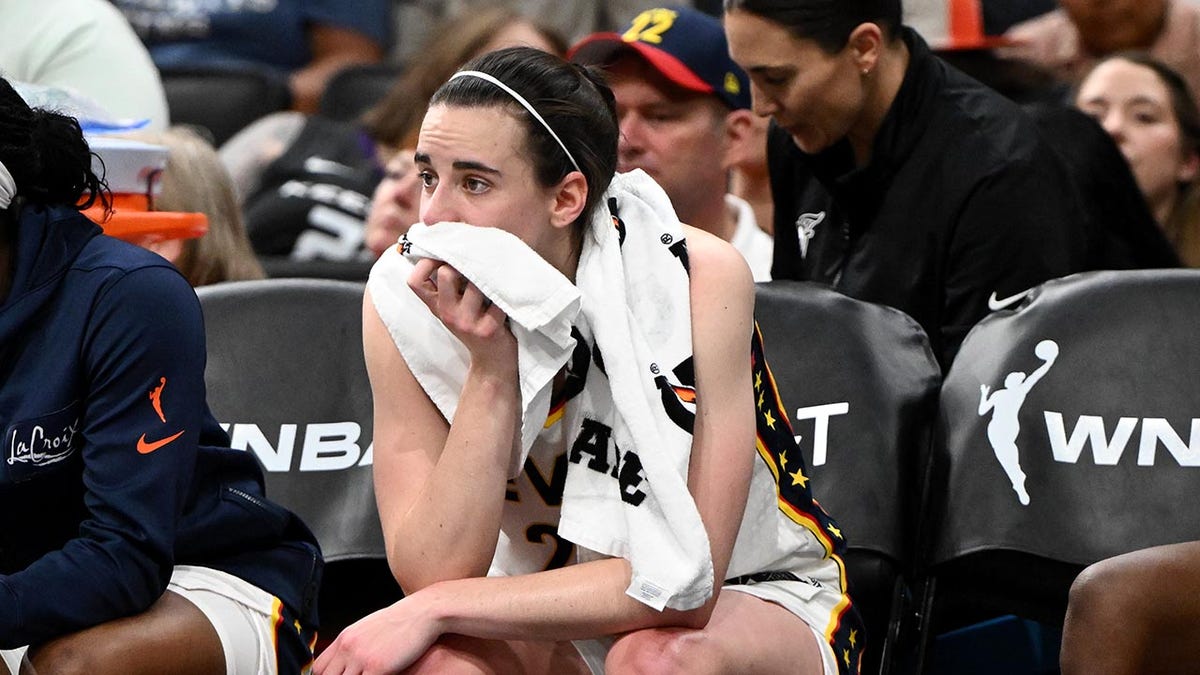 Caitlin Clark sitting on the bench during a basketball game at TD Garden