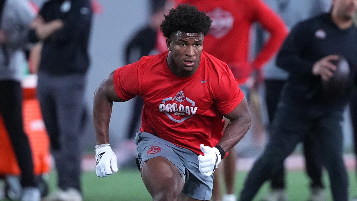 Caleb Downs wearing Ohio State Buckeyes uniform participating in drills indoors.