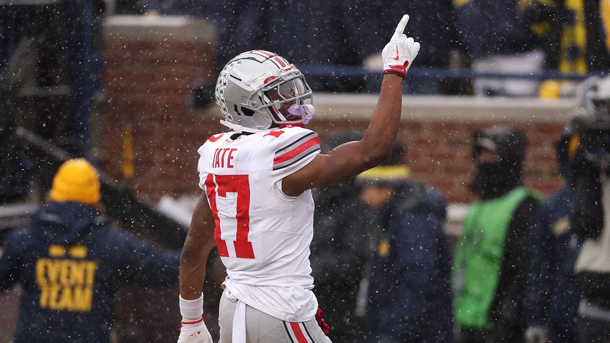Carnell Tate celebrating a touchdown during a football game at Michigan Stadium
