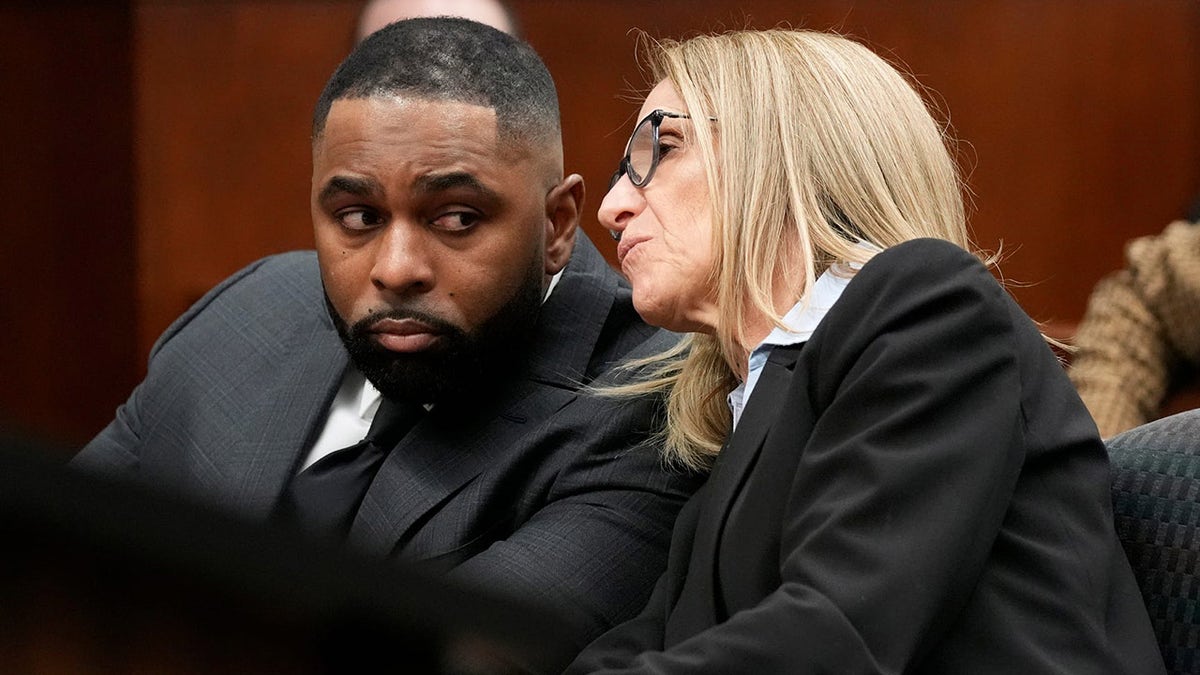 Former University of Michigan football coach Sherrone Moore listening to attorney Ellen K. Michaels in court