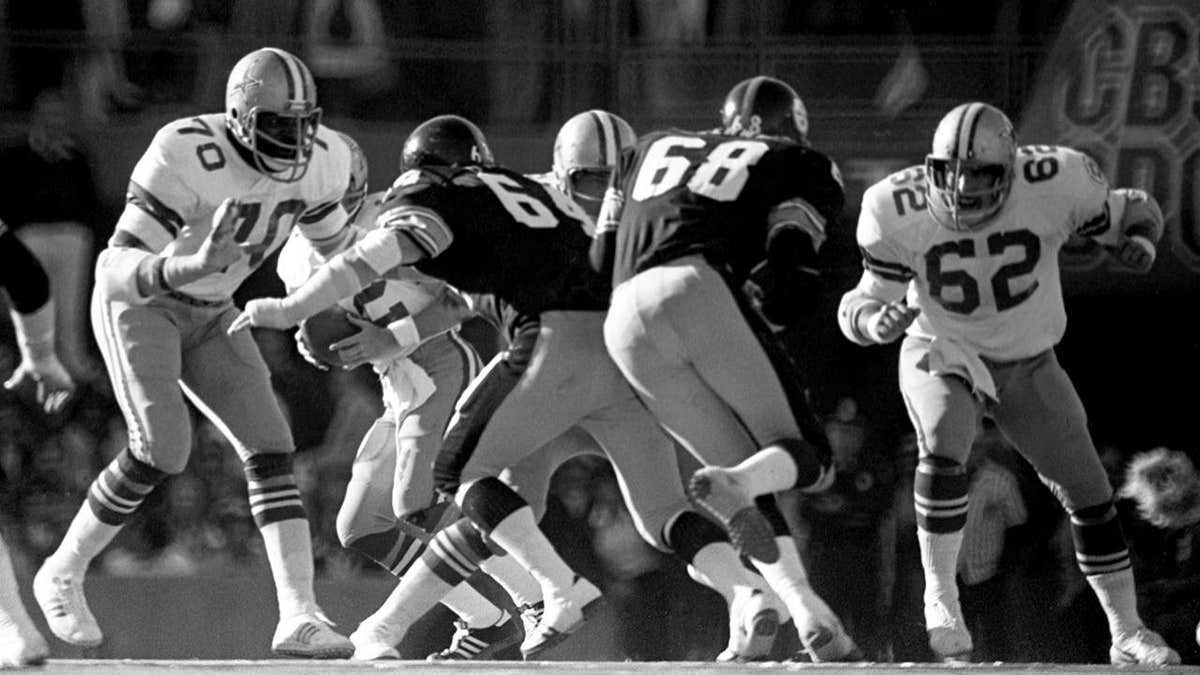 Offensive linemen Rayfield Wright and John Fitzgerald blocking defensive linemen Steve Furness and L.C. Greenwood during Super Bowl X