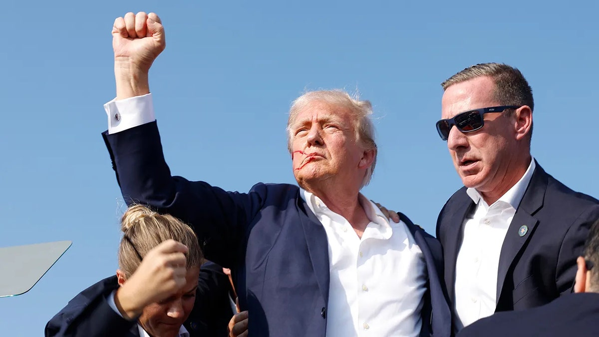 Former President Donald Trump being rushed offstage at a rally in Butler, Pennsylvania