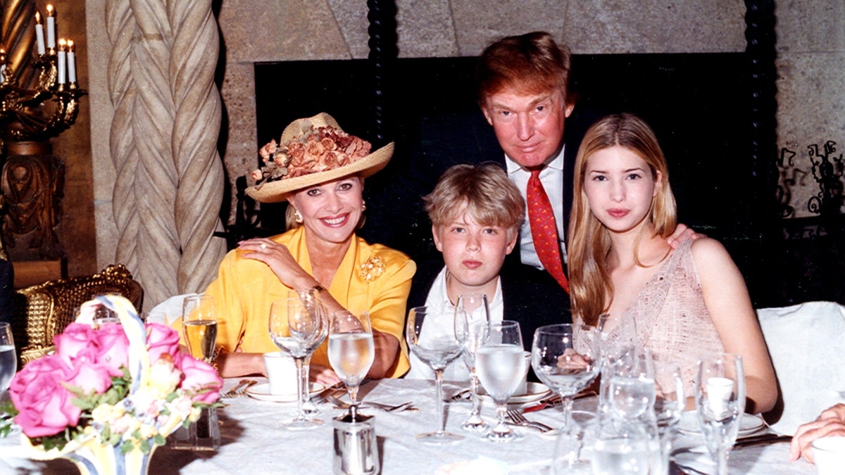 Donald Trump sitting at a table with Ivana Trump, Eric Trump, and Ivanka Trump at Mar-a-Lago estate