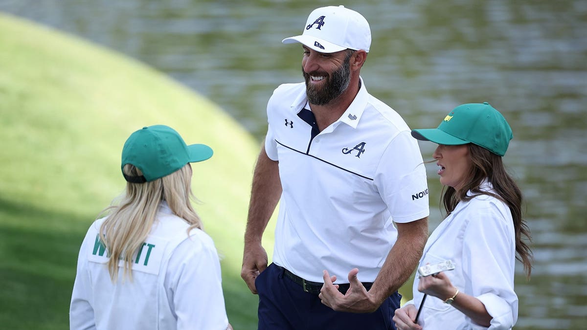 Nicole Willett talking with Dustin Johnson and Paulina Gretzky on the ninth green at Augusta National Golf Club