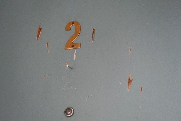 The door to a neighbour’s unit which locals say Graham damaged in 2022.