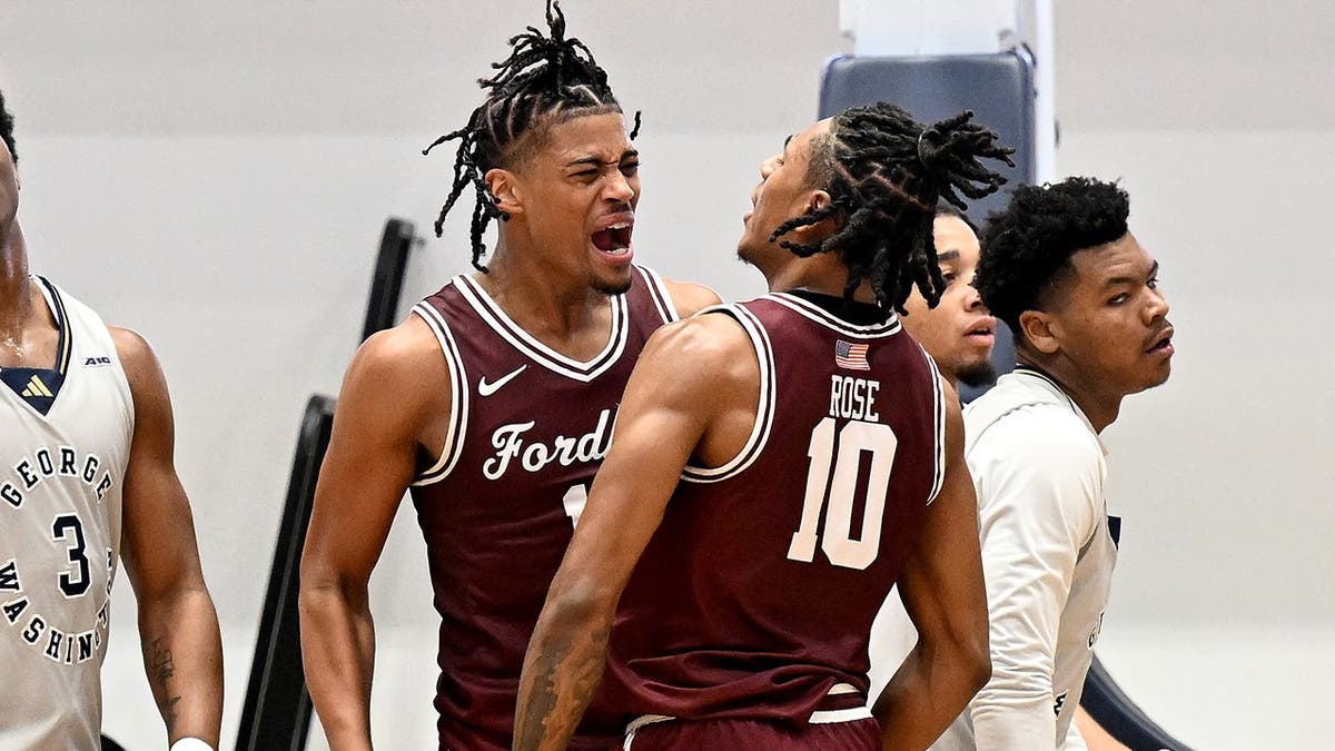 Elijah Gray and Kyle Rose celebrating during a basketball game at Charles E. Smith Athletic Center