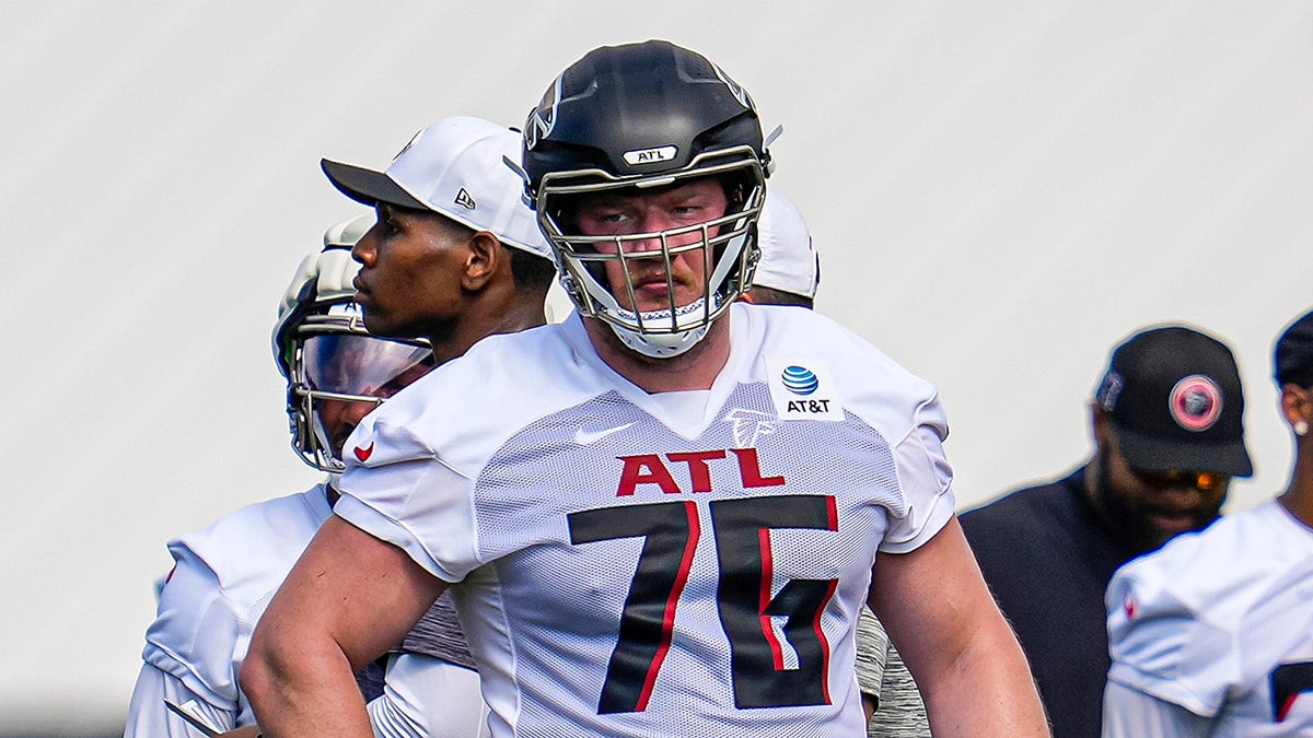 Atlanta Falcons offensive tackle Kaleb McGary standing on the field during training camp