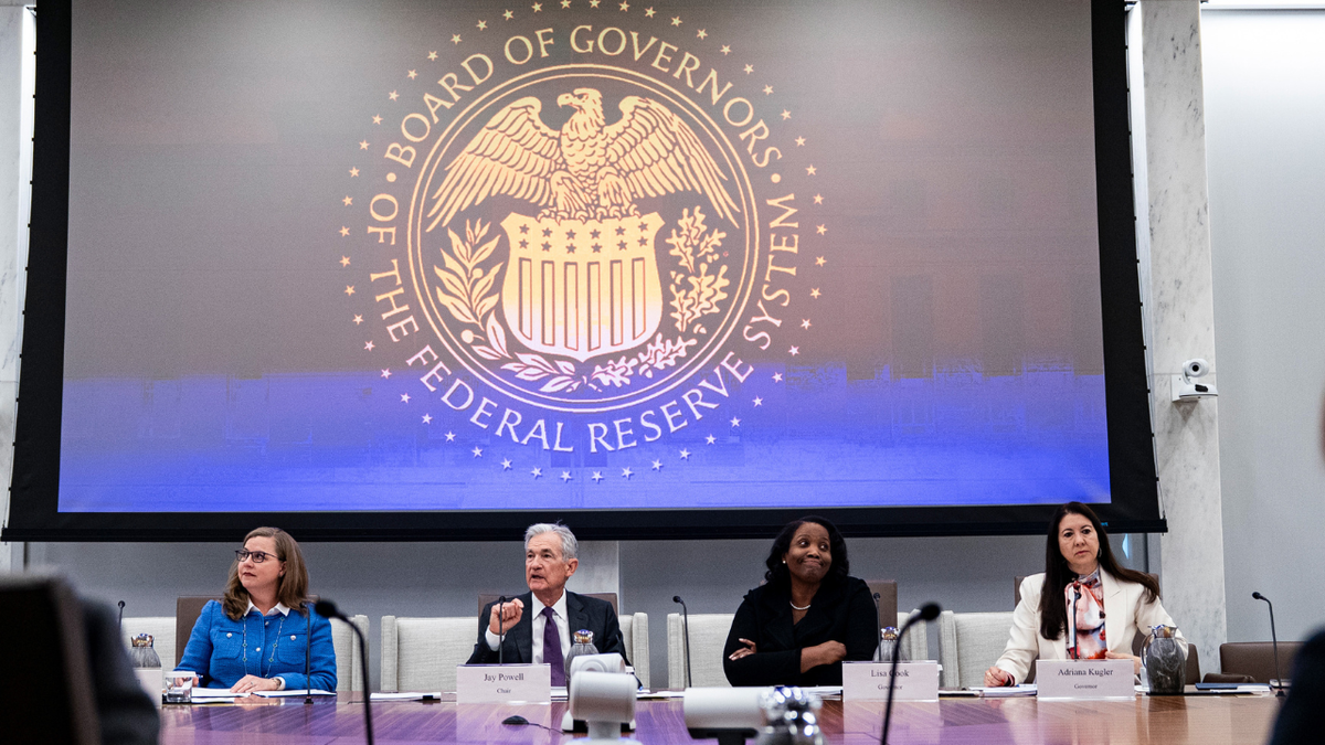 U.S. Federal Reserve Chairman Jerome Powell seated with Federal Reserve Board of Governors members in a meeting room.