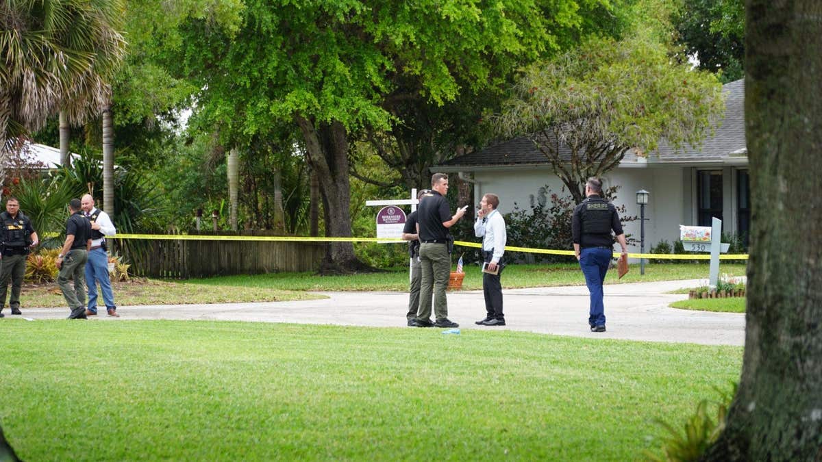 A man lying on the ground surrounded by emergency responders in Florida