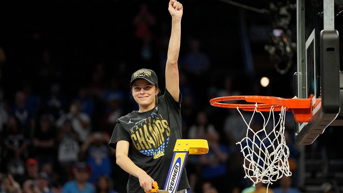 UCLA guard Gabriela Jaquez cutting down basketball net in celebration