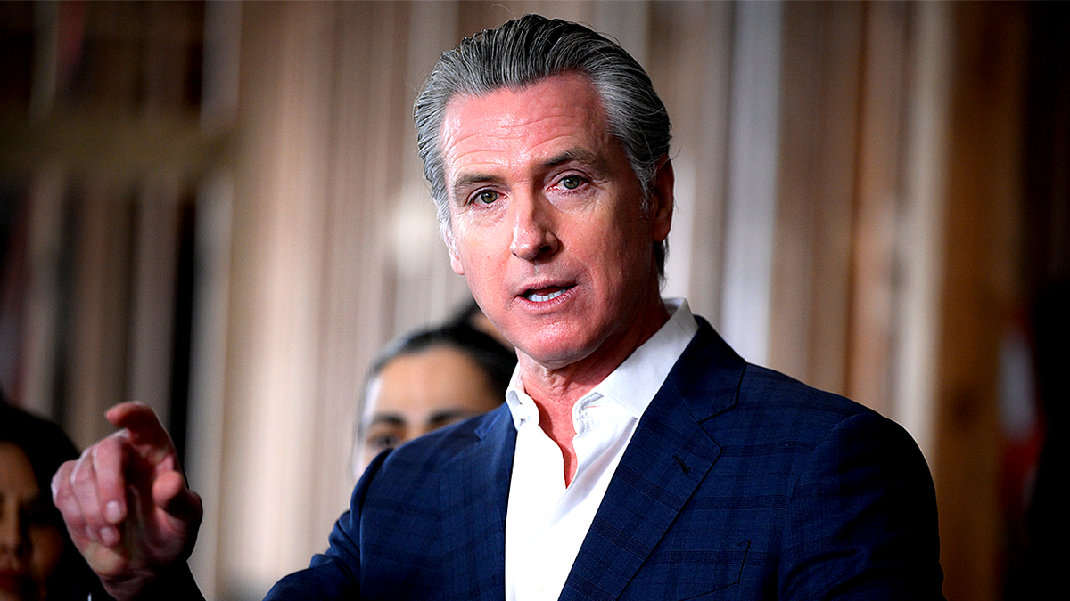 Governor Gavin Newsom speaking and pointing finger at a press conference in Hayward, California