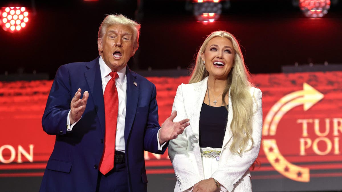 Erika Kirk and President Donald Trump standing onstage at State Farm Stadium