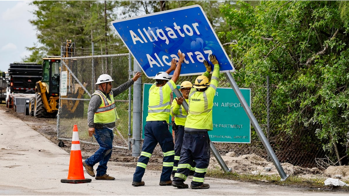 Workers install a permanent Alligator Alcatraz sign. The facility is within the Florida Everglades, 36 miles west of the central business district of Miami, in Collier County. Florida, on Thursday, July 3, 2025. (Photo via Getty Images)