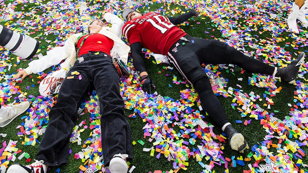 Jacob Rodriguez celebrating with his wife Emma Rodriguez at AT&T Stadium