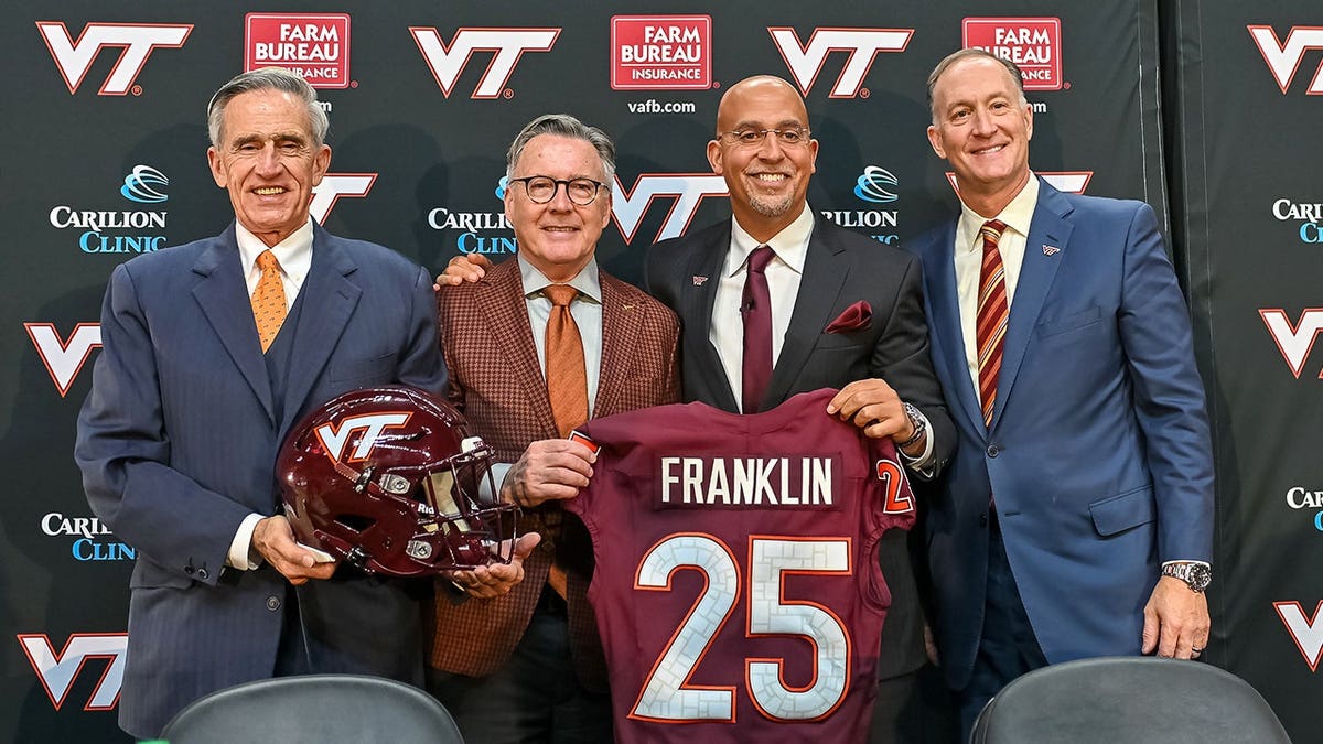 John Rocovich, Timothy Sands, James Franklin and Whit Babcock holding a Virginia Tech jersey at a press conference