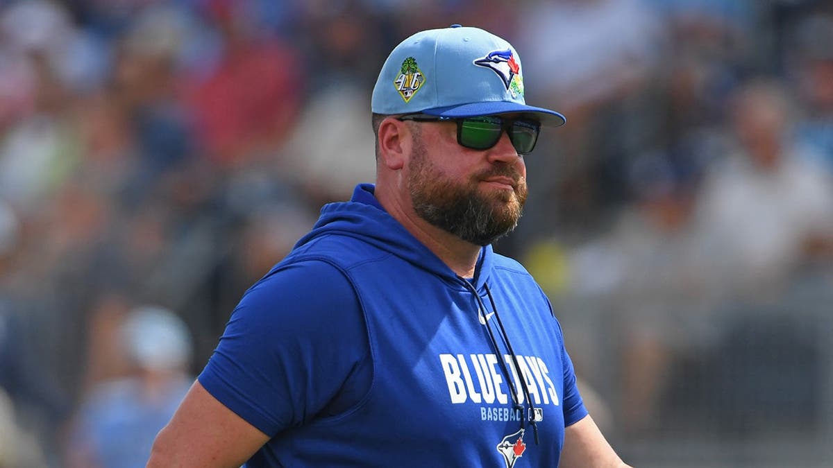 John Schneider walking back to dugout during spring training game.