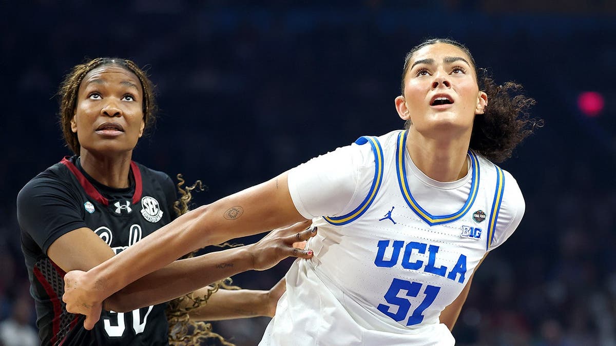 Lauren Betts and Maryam Dauda competing for position during a basketball game.