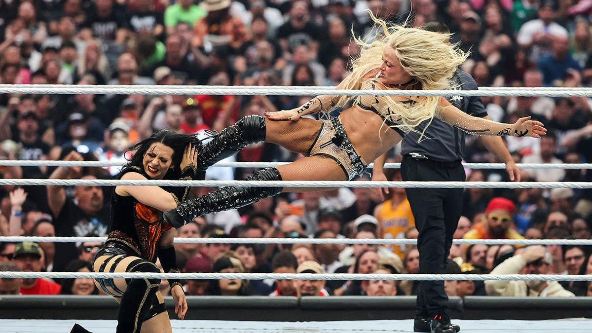 Liv Morgan kicking Stephanie Vaquer during a wrestling match at Allegiant Stadium