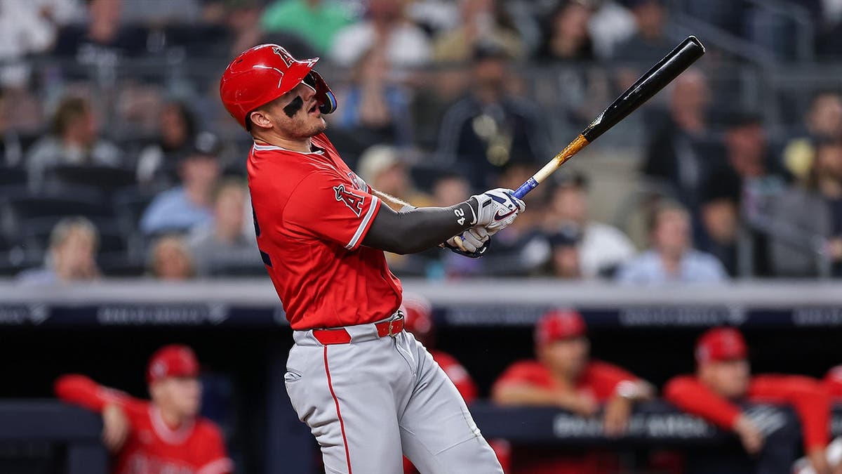 Mike Trout hitting a two-run home run at Yankee Stadium.