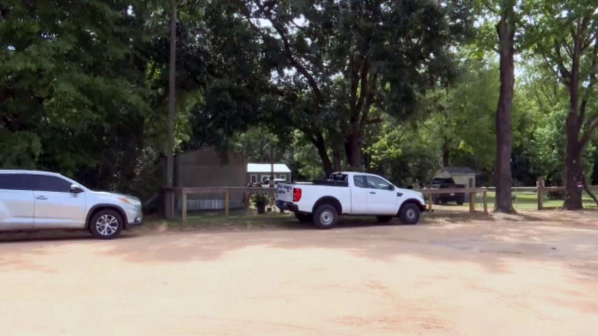 A white truck outside a Wilmer, Ala., home, the scene of a triple homicide.
