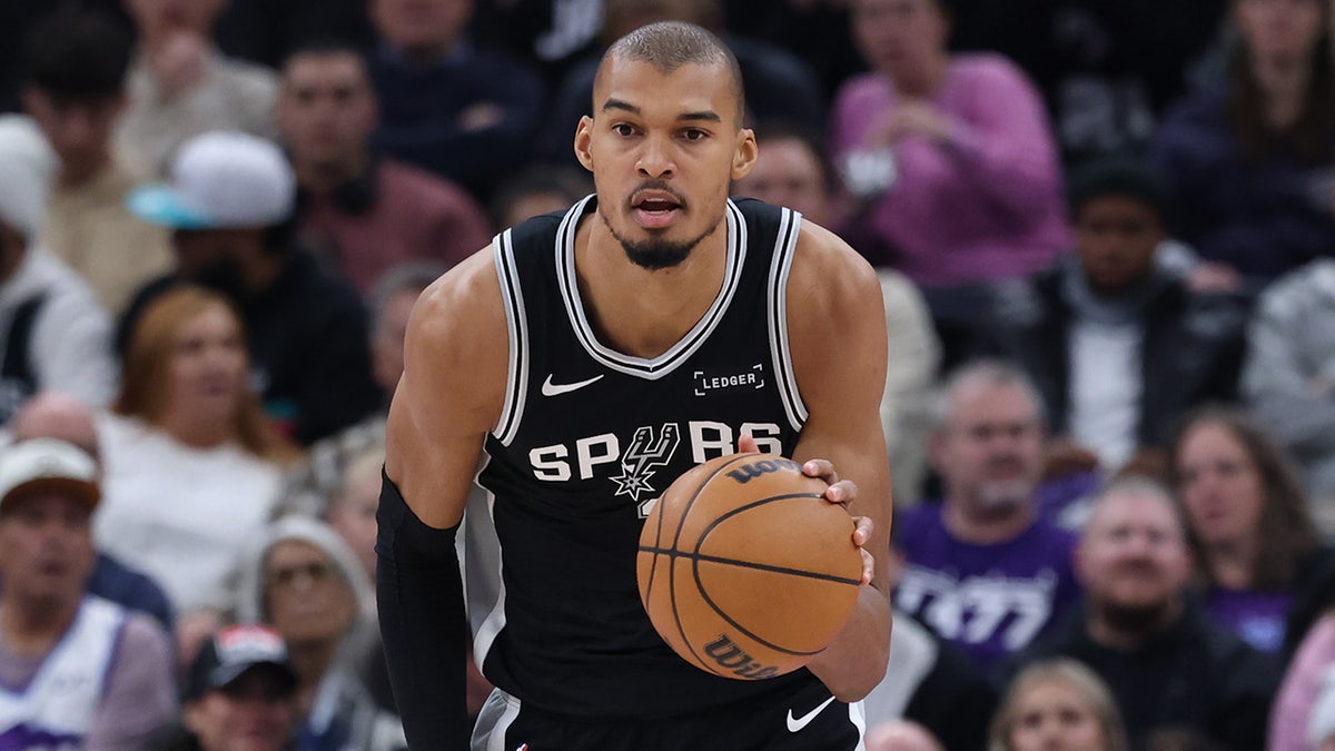 San Antonio Spurs forward Victor Wembanyama dribbling basketball upcourt against Utah Jazz
