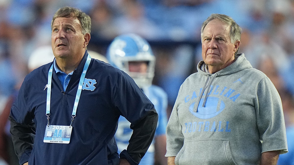 North Carolina football head coach Bill Belichick and General Manager Michael Lombardi looking on from the sideline at Kenan Memorial Stadium