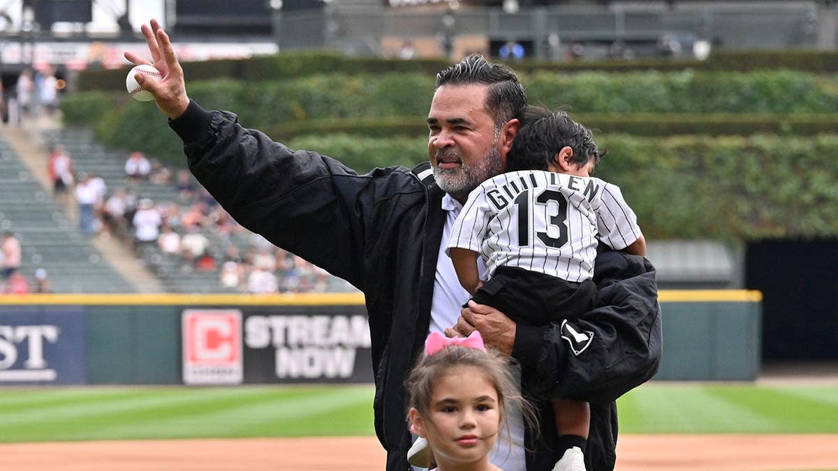 Former Chicago White Sox manager Ozzie Guillen throwing ceremonial first pitch with family at Rate Field