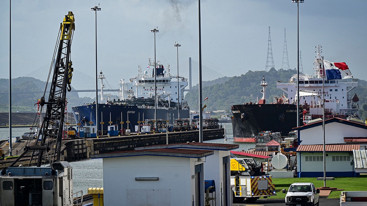 Two cargo ships entering the Miraflores Locks of the Panama Canal in Panama City