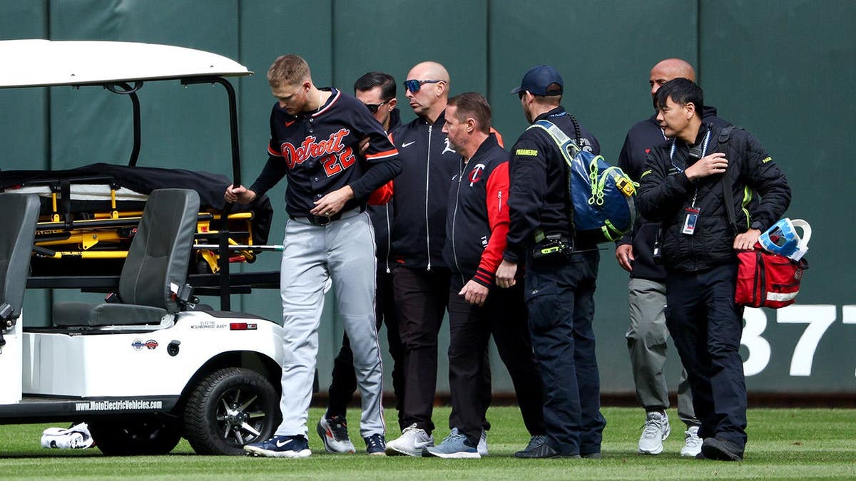 Detroit Tigers center fielder Parker Meadows being helped off the field after collision