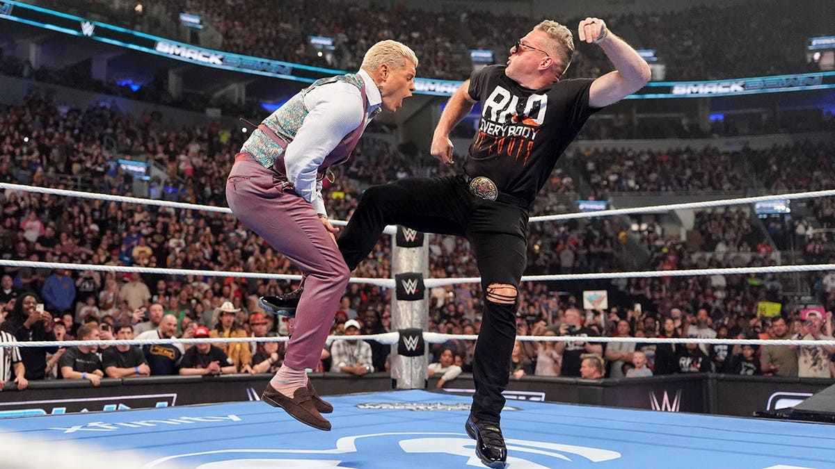 Pat McAfee punting Cody Rhodes during SmackDown at Enterprise Center in St. Louis