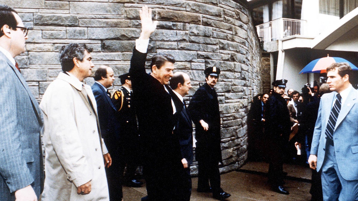 President Ronald Reagan waving to onlookers outside the Washington Hilton