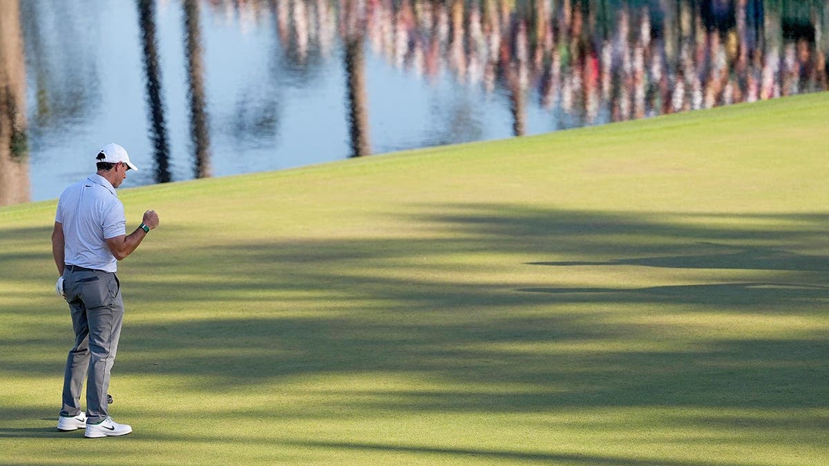 Rory McIlroy celebrating after a putt on the 16th hole at Augusta National Golf Club