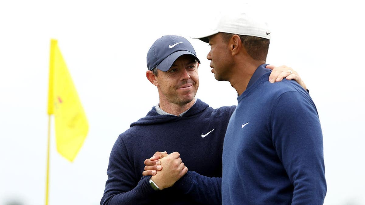 Rory McIlroy shaking hands with Tiger Woods on the 18th green at Augusta National Golf Club