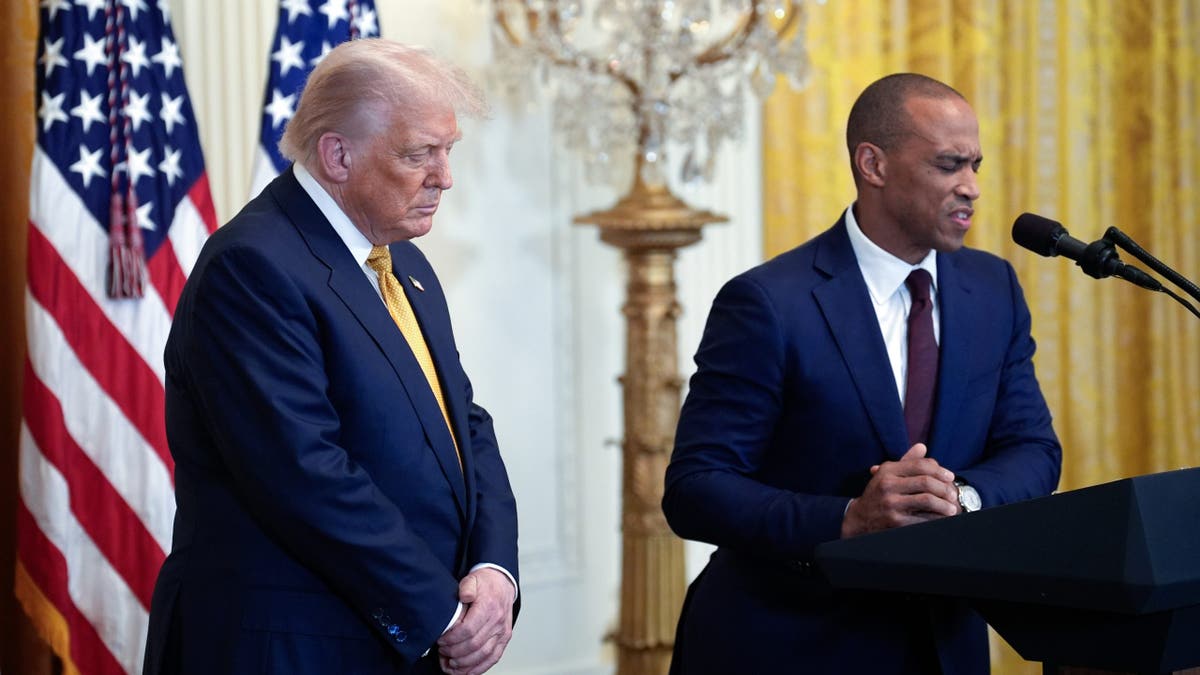 President Donald Trump and Eric Scott Turner standing together in the East Room of the White House.