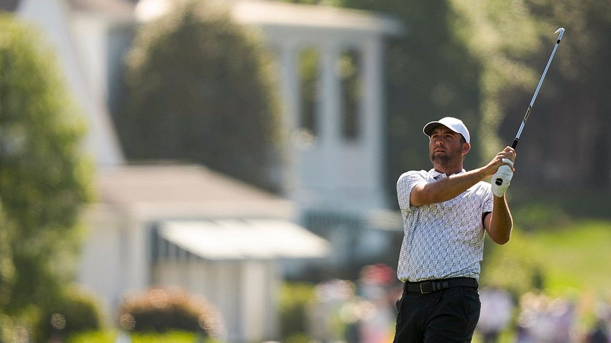 Scottie Scheffler watching his shot on the first hole at Augusta National Golf Club