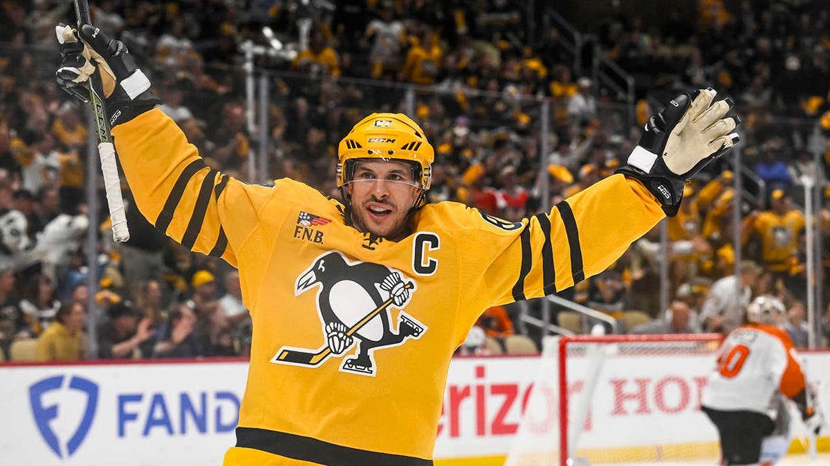 Sidney Crosby celebrating a goal during a hockey game at PPG Paints Arena in Pittsburgh