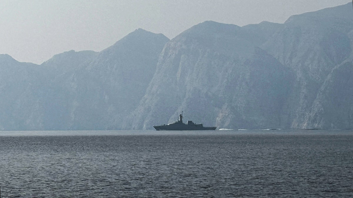 A navy vessel sailing in the Strait of Hormuz waterway.