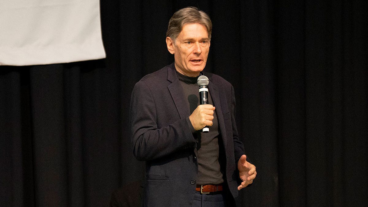 Tom Malinowski speaking on stage at a meet and greet event