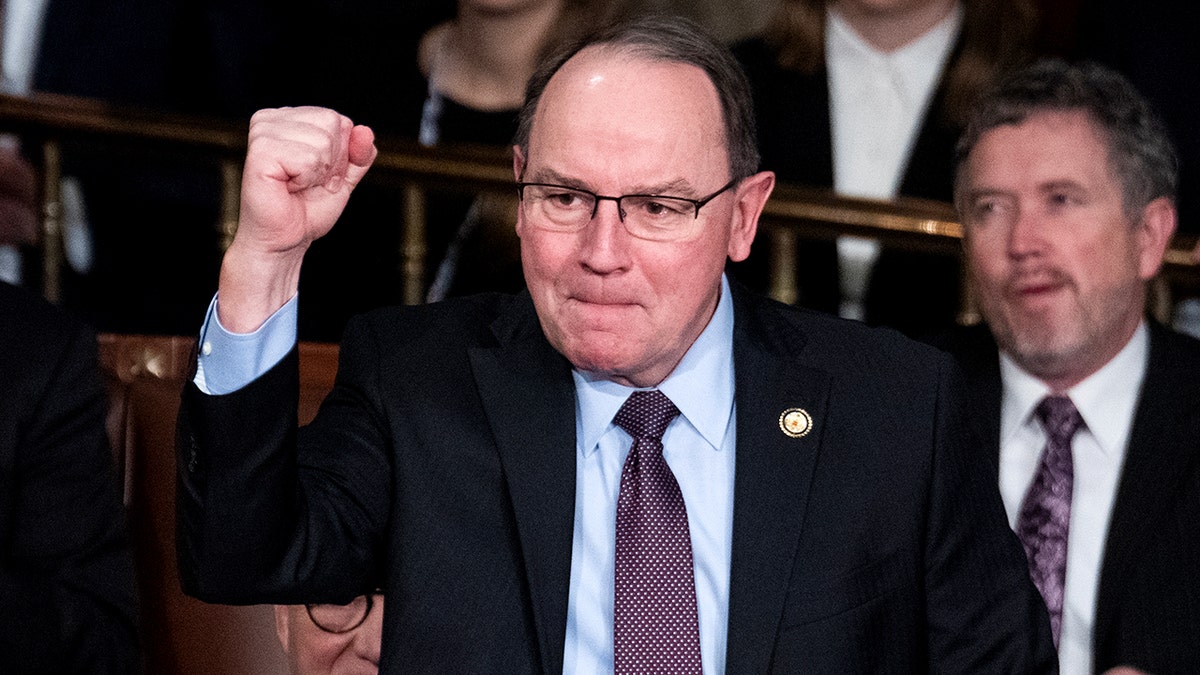 Rep. Tom Tiffany cheering and holding up a fist in the House chamber