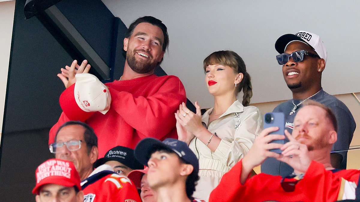 Travis Kelce, Taylor Swift and Aric Jones attend the Stanley Cup Final