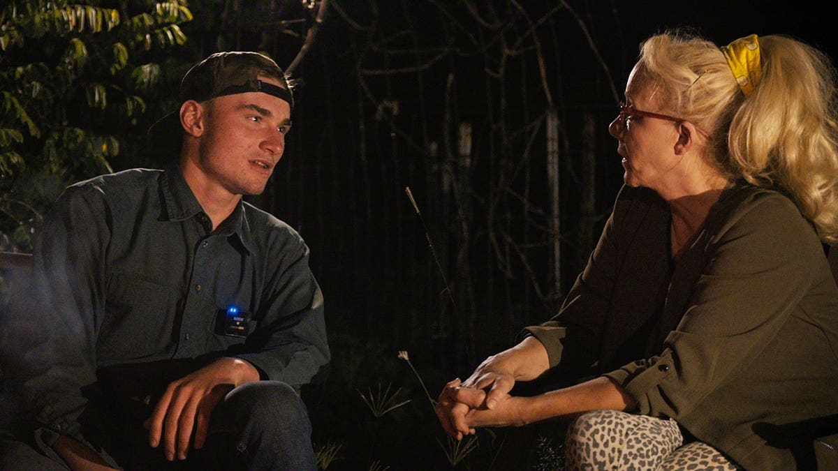 Warren Levi and Christine Marie standing together in a scene from Trust Me The False Prophet Season 1
