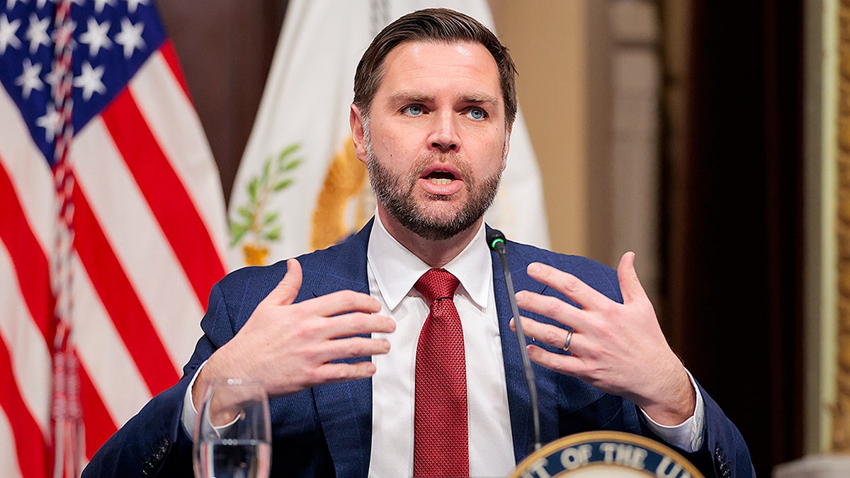 Vice President JD Vance speaking at a podium during a meeting