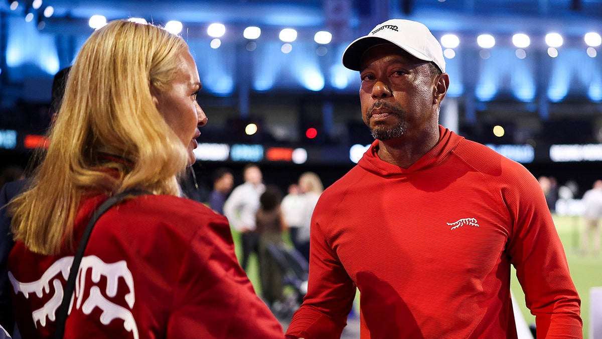 Tiger Woods talking with his girlfriend Vanessa Trump at a golf course