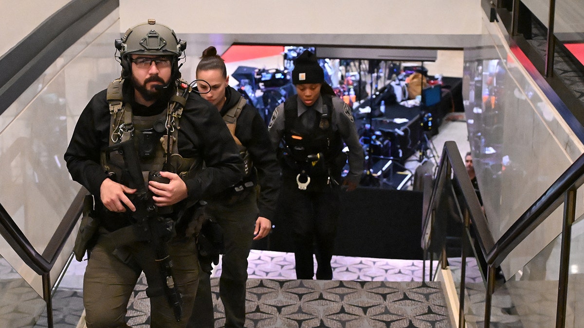 US Marshalls walking through the lobby of the Washington Hilton with guns drawn