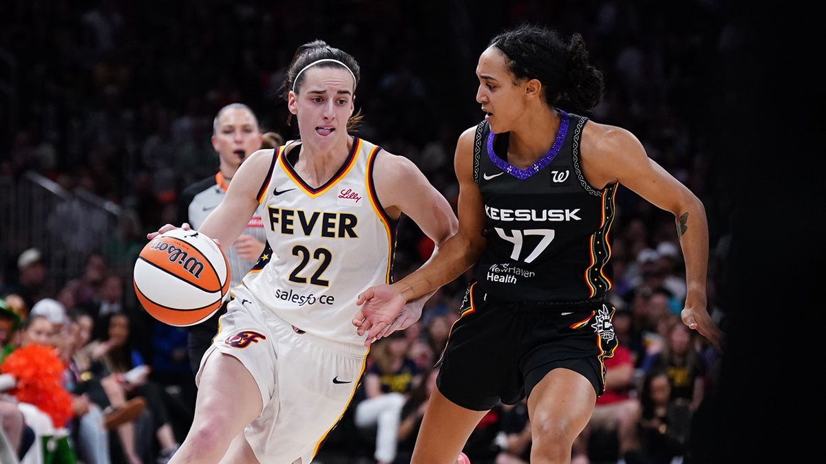Indiana Fever guard Caitlin Clark drives the ball against Connecticut Sun guard Leila Lacan at TD Garden