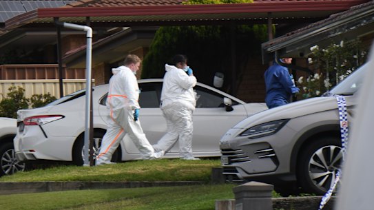 Police at the house in Rosemeadow, where three people died in an attack on Sunday morning.