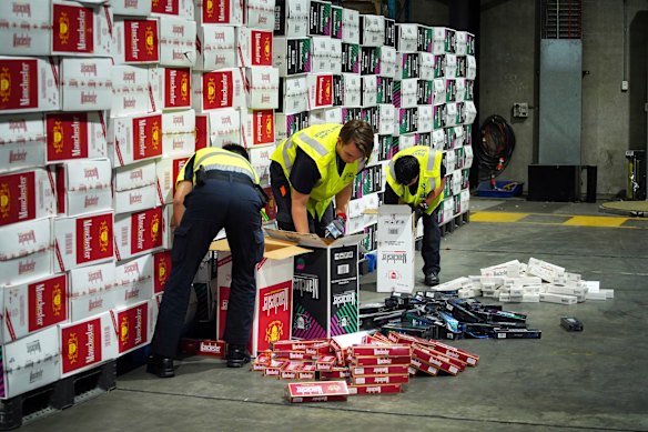 Border Force officers check illegal cigarette imports found in shipping containers in Melbourne.