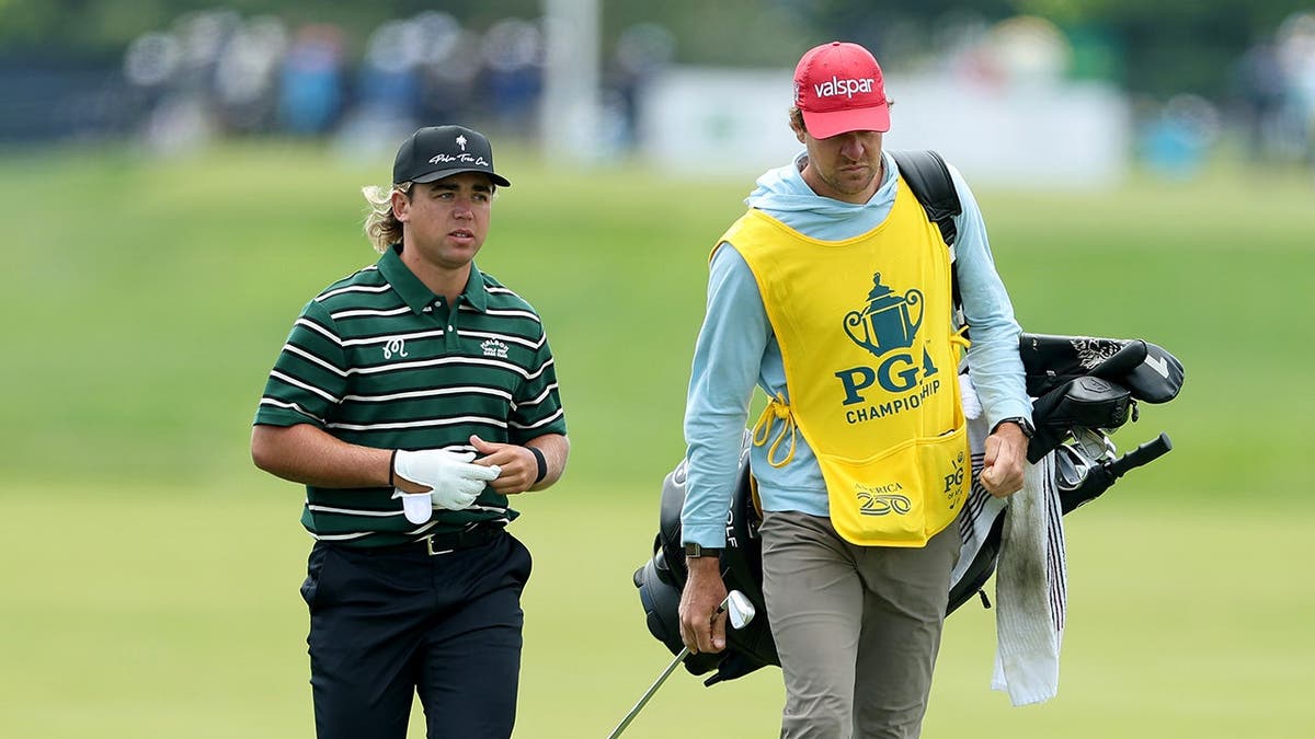 Garrick Higgo walking the 16th hole with caddie Austin Gaugert at Aronimink Golf Club