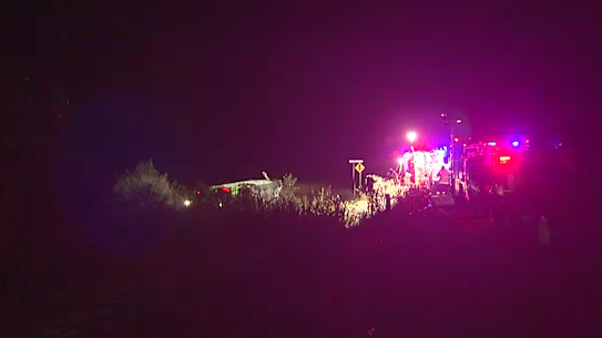 One person is dead and at least two others are fighting for life after a bus rollover in north Queensland injured about 20 people.